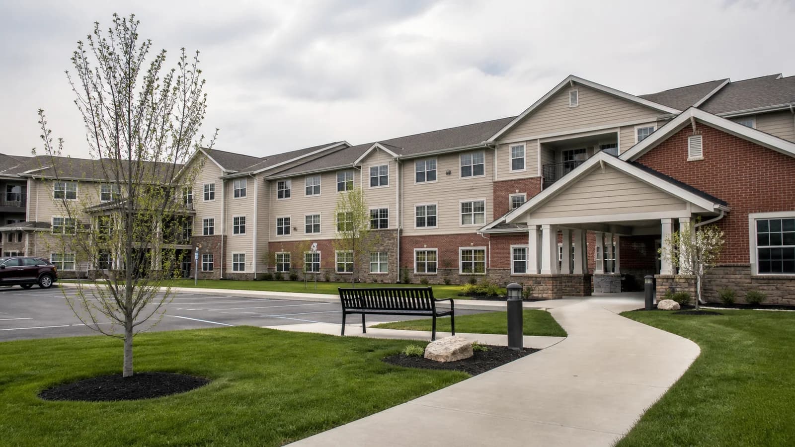 Editorial view of Cobblestone Manor exterior and accessible senior apartment entrance in Grove City, Ohio.