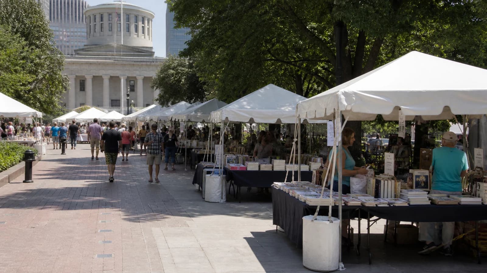 Readers attending author events near Columbus Main Library and Topiary Park.