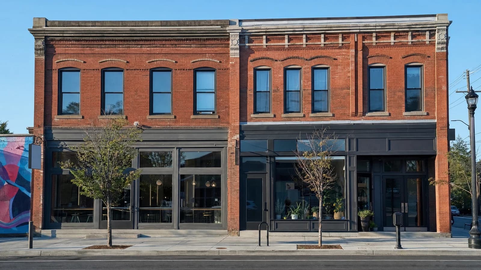 Illustrated pair of distinct West Broad Street buildings awaiting documented renovation work.