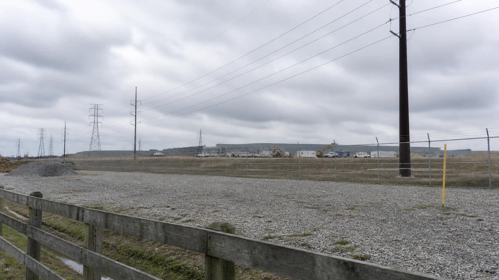 Illustrated New Albany data-center campus beside distinct electrical substation equipment.