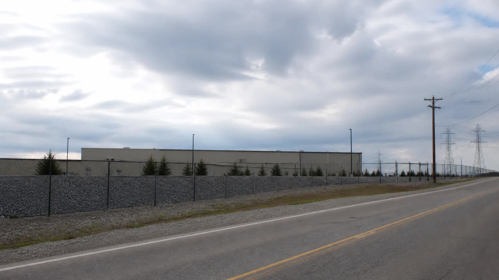 Illustrated Ohio policy document beside a data-center campus with new requests marked paused.
