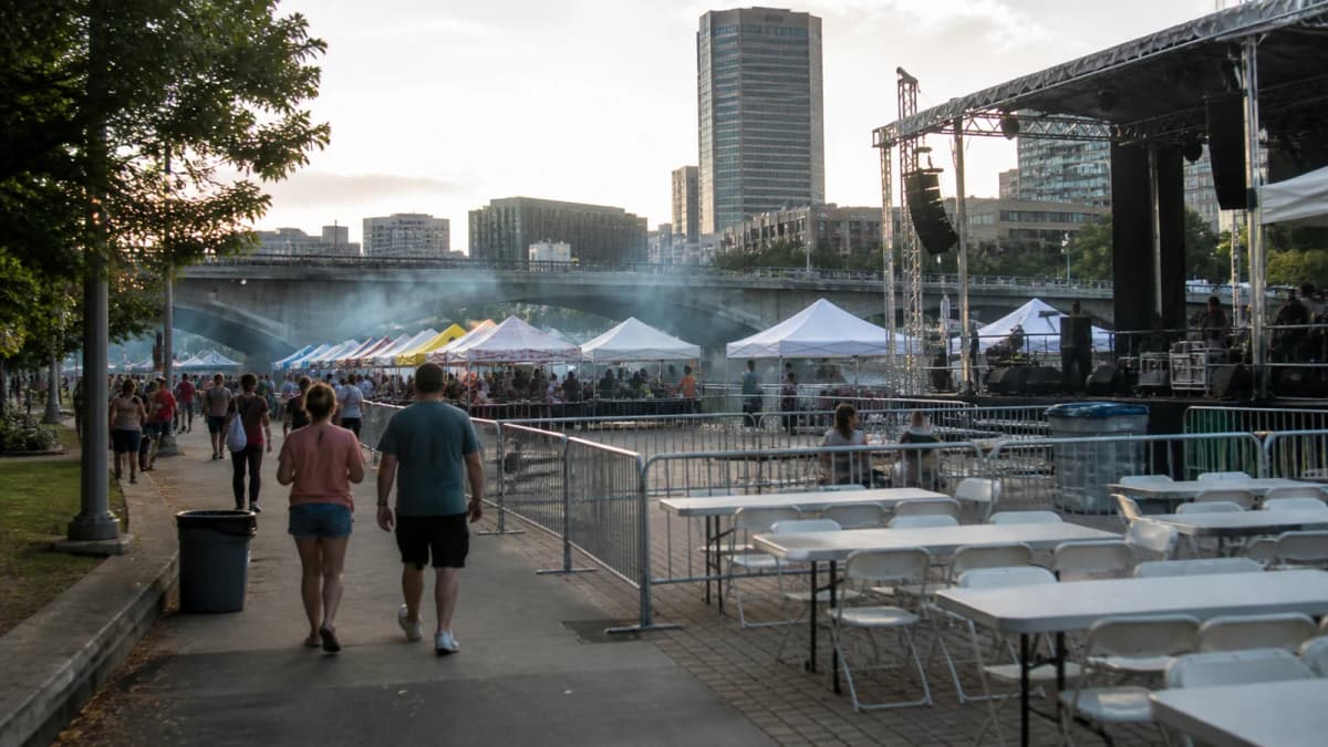 AI-generated illustration of a riverside stage, temporary tables and visitors at an outdoor event.