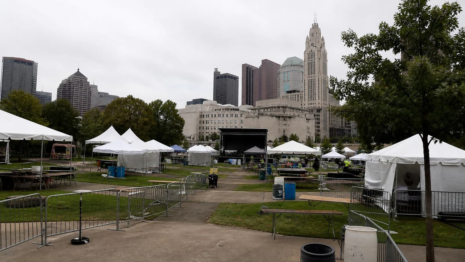 Illustrated outdoor cultural festival beside a separate downtown theater entrance.