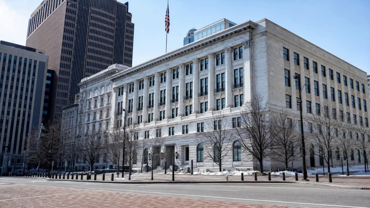 AI-generated illustration of a large civic-style stone building beside a paved downtown street.