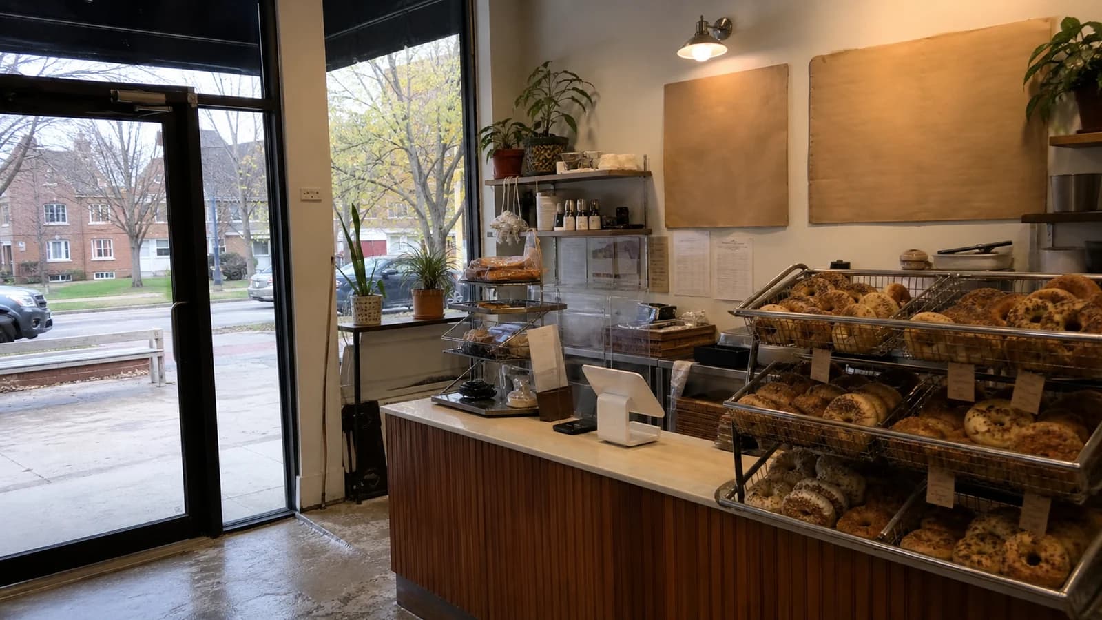 Editorial view of 6115 McNaughten Center storefront and single tray of distinct fresh bagels in East Columbus, Ohio.