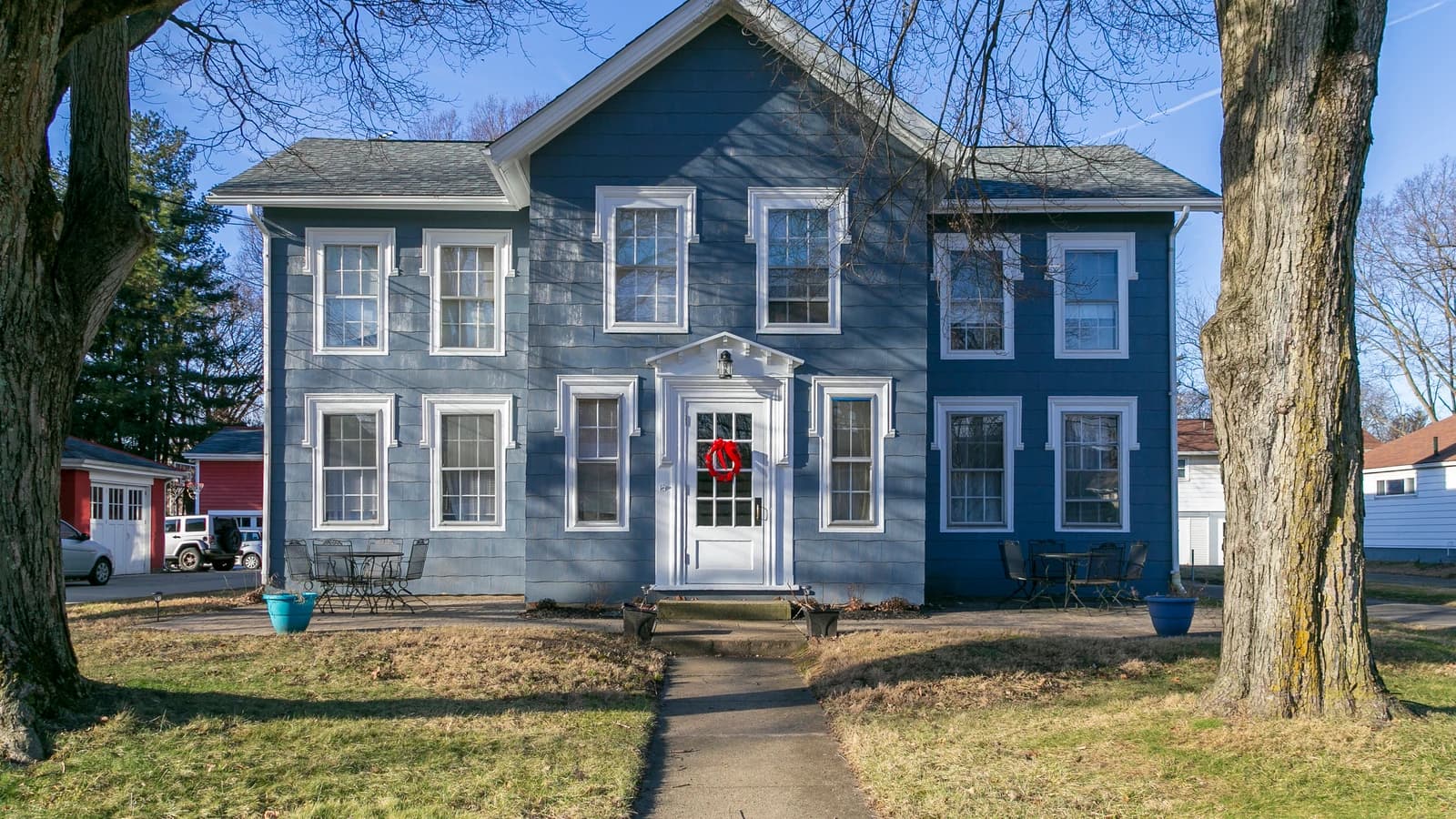 Archival photograph of a blue house with a front porch and leafless trees in Westerville, Ohio.
