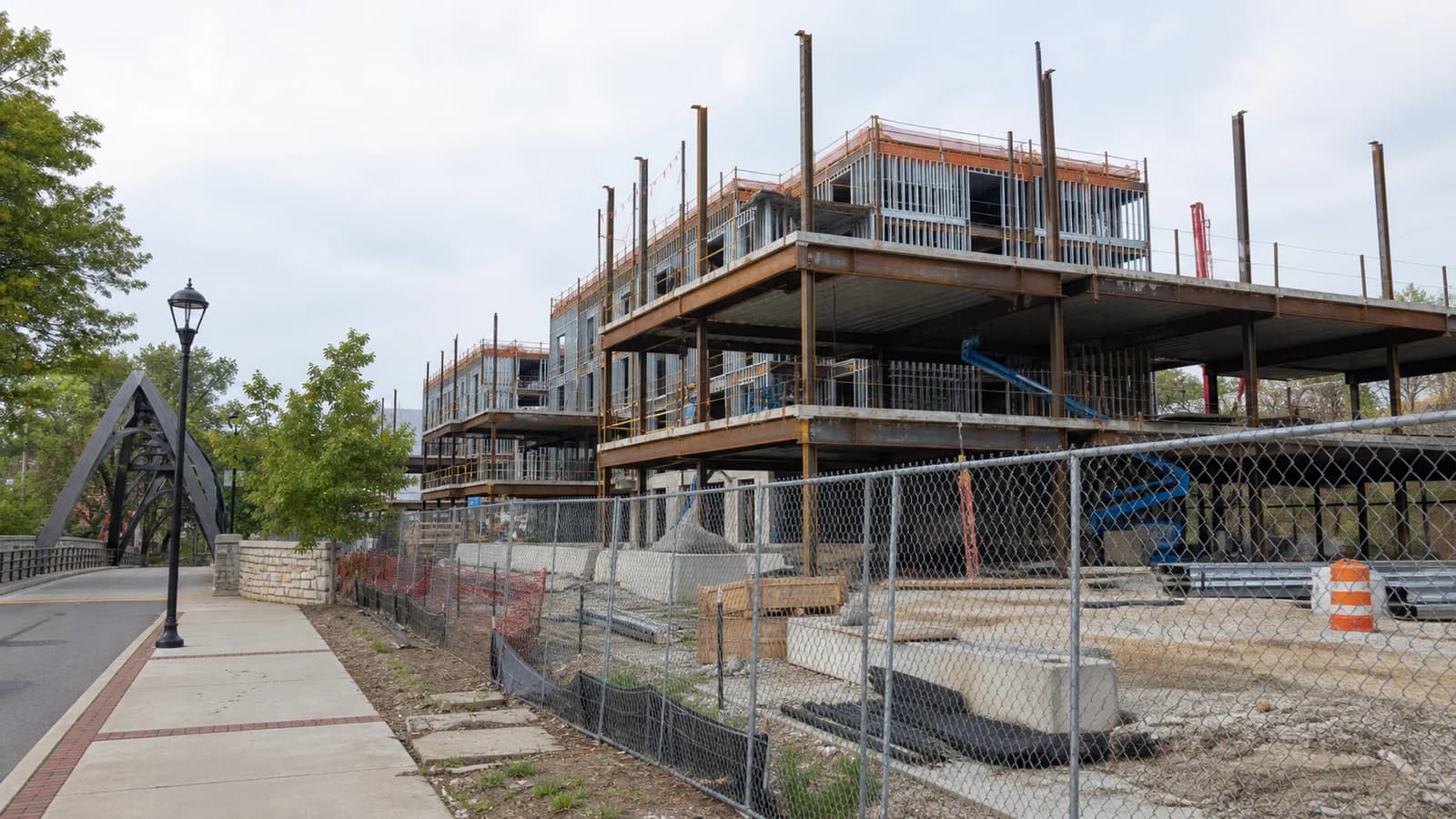 Illustration of a mid-rise condo building under construction in a riverside mixed-use district in Dublin, Ohio.