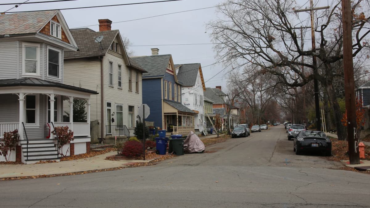 Archival photograph of older houses and a sidewalk in Victorian Village, Columbus.