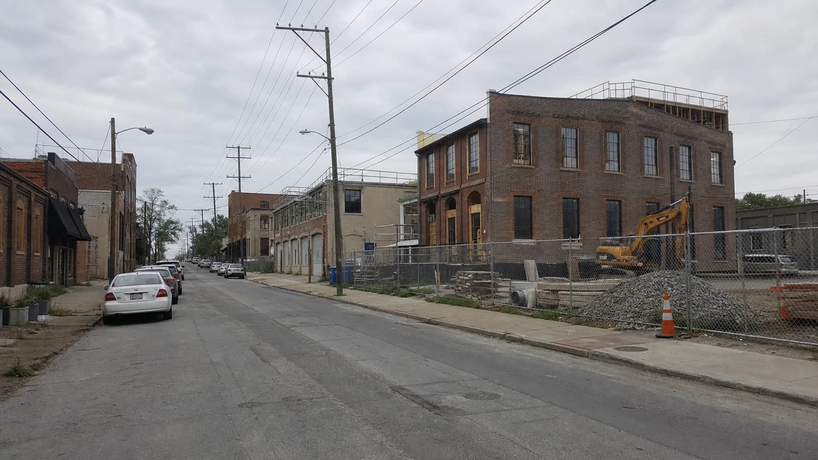 Different housing projects under construction within an established Franklinton streetscape.